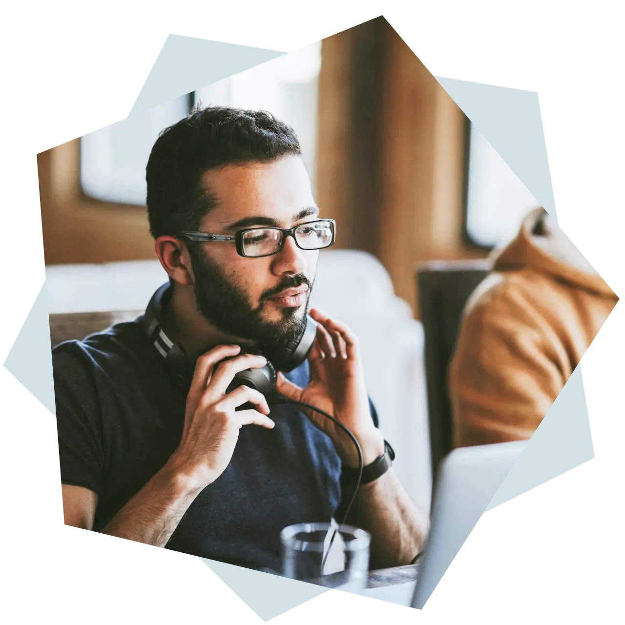man wearing headphone and looking at laptop image